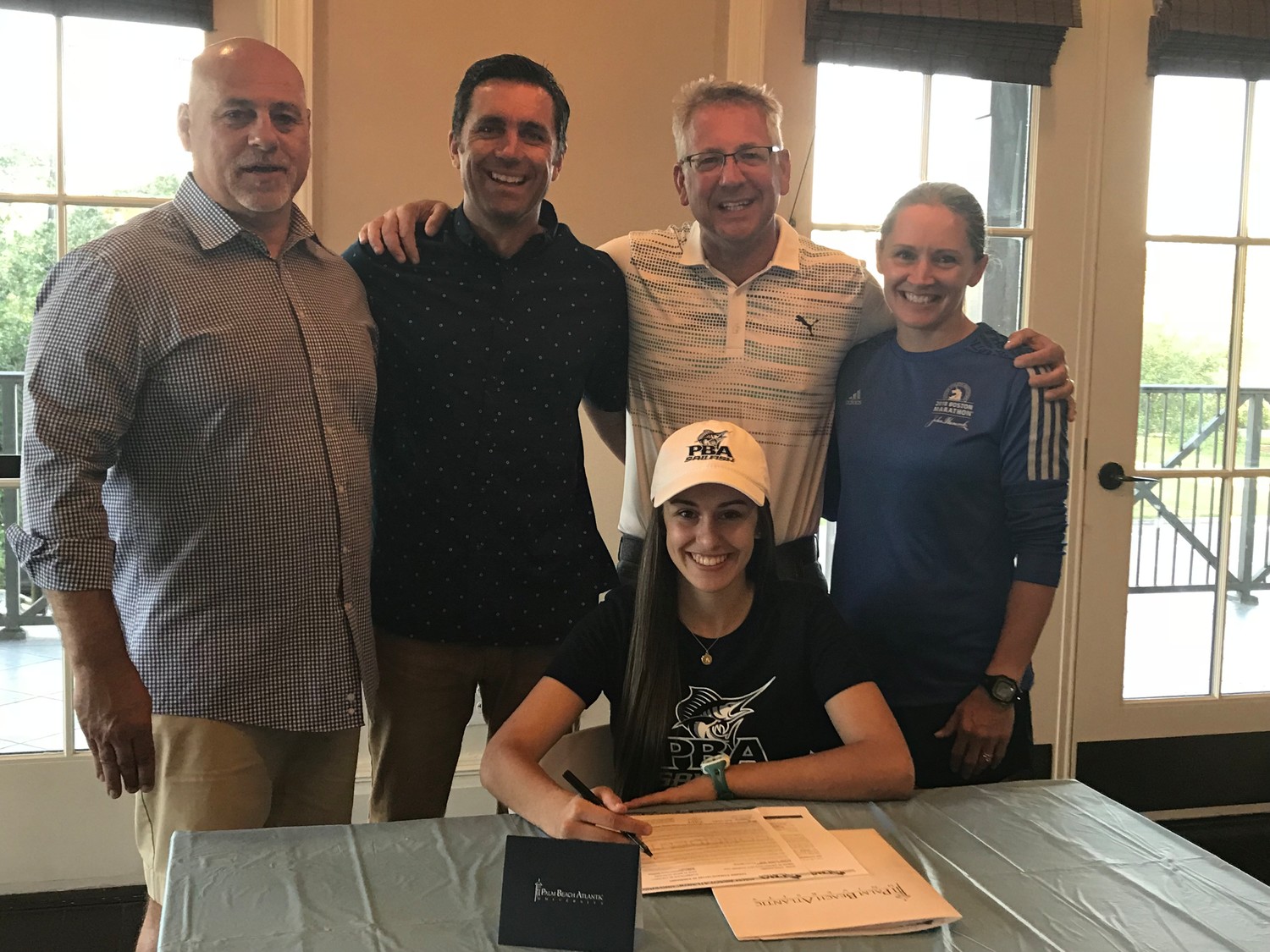 Ponte Vedra cross country runner Avery Knehans gathers with her family and coaches last week to celebrate her commitment to Palm Beach Atlantic University. Displayed in the photo with Avery is father Mike Knehans (from left) and coaches Kerry Mowlam, Rob Circelli and Amy Schottel.